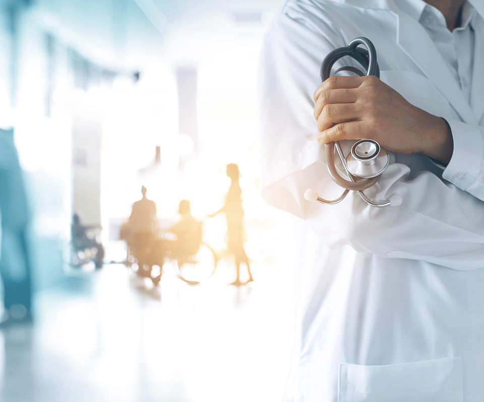 Doctor in a medical environment holding medical equipment